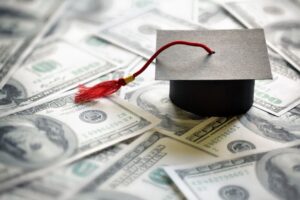 A graduation cap on money symbolling student loan debt in British Columbia